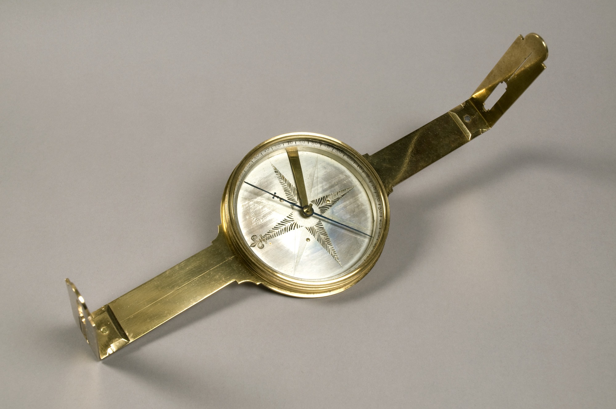Brass surveyor’s compass with a silvered dial and two sighting arms